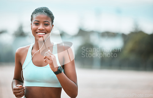 Image of Portrait, outdoor and black woman running, fitness and workout goal for wellness, health and cardio. Face, female person and runner with earphones, motivation and exercise with training and sports