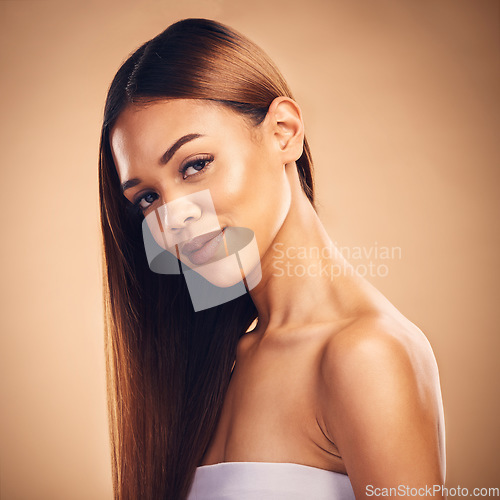 Image of Woman, hair style and wellness in studio portrait with cosmetic beauty, glow and shine by brown background. Girl, latino model and haircare with makeup, health and aesthetic with growth by backdrop