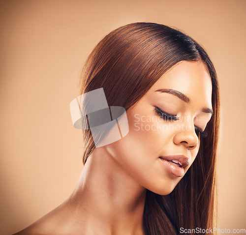 Image of Beauty, hair and face of woman in studio for wellness, keratin treatment and haircare aesthetic. Salon, hairdresser and female person with makeup on orange background for growth, shine and texture