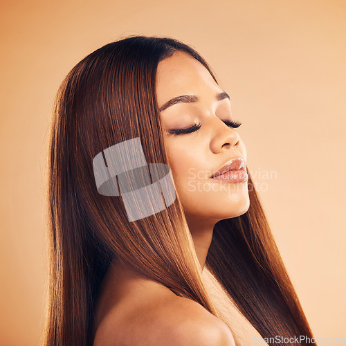 Image of Hair care, face and woman in studio for wellness, keratin treatment and cosmetics with eyes closed. Beauty salon, hairdresser and female person on orange background for growth, shine and texture