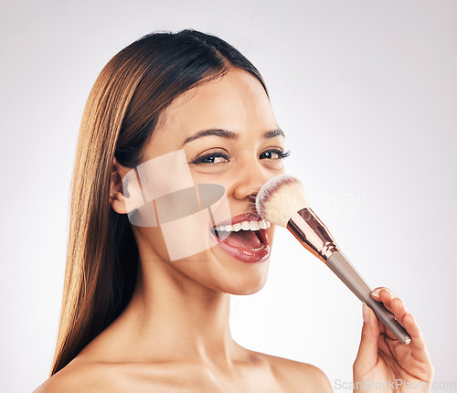 Image of Makeup brush, portrait and excited woman in studio with a natural, cosmetic and luxury face routine. Glamour, cosmetology and female model with beauty product for cheeks isolated by white background.