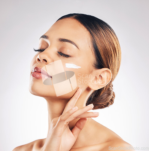 Image of Skincare, face cream and woman relax in studio for cosmetic, wellness or self love on grey background. Facial, beauty and female model with sunscreen, moisturizer or collagen mask for hydration