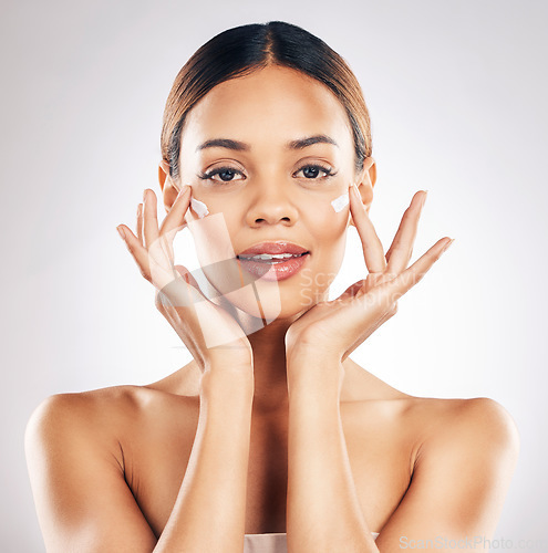 Image of Skincare, portrait and face cream for woman in studio with healthy, glowing or anti aging beauty on grey background. Facial, hands and female model relax with dermatology, sunscreen and lotion