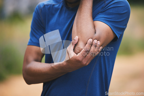 Image of Sports, fitness and man with pain in elbow after workout, exercise and marathon training outdoors. Medical emergency, health and male person with muscle strain, arm injury and joint ache in park