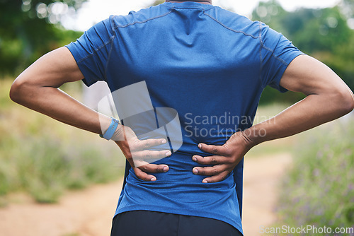 Image of Sports, fitness and man with back pain in park after workout, exercise and marathon training in nature. Medical emergency, body health and male person with muscle strain, spine injury and joint ache