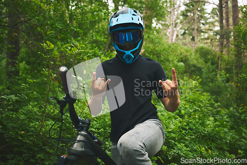 Image of Mountain bike, nature and man with rock on sign for freedom, adventure and forest racing. Bicycle athlete, sports and hands with horn gesture for action, off road competition or emoji of race winner