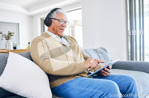 Image of Old man laughing, relax with tablet and headphones at home, retirement and technology, streaming comedy online. Surfing internet, watching funny video and elderly male person sitting on couch