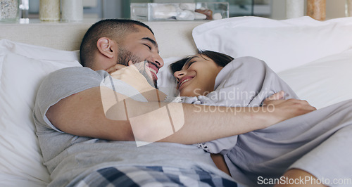 Image of Couple, love and smile in bed, bonding and romance of intimacy, special moment and trust together at home. Happy young man, woman and partner in relationship, honeymoon and relax for care in bedroom