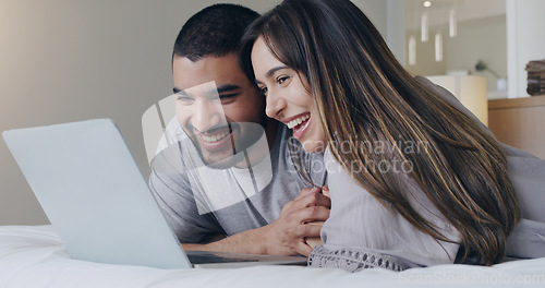 Image of Happy, couple and watching movie on laptop in bedroom for online subscription, media download or relax together. Young man, woman and computer technology for streaming, internet or connection at home