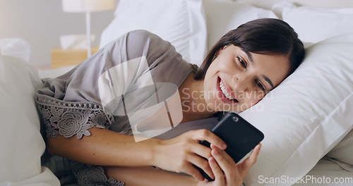 Image of Happy, woman and texting on cellphone in bedroom for online dating app, reading social media notification and relax. Female typing on smartphone in bed, morning and mobile internet download at home