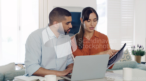 Image of Laptop, documents and couple planning bills, debt or mortgage payments together in the living room. Technology, financial paperwork and young man and woman paying with online banking in their home.