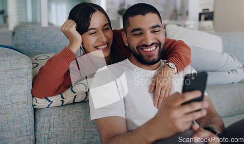 Image of Home, sofa and couple with phone online for social media, browse website or internet news. Communication, love and happy man and woman on smartphone for quality time, bonding and relax in living room