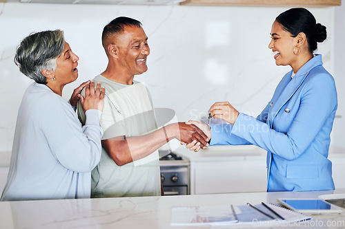 Image of Senior couple, real estate and keys with handshake, agent or new home with congratulations on deal. Excited man, women and realtor for agreement, property or sale with smile, retirement or investment