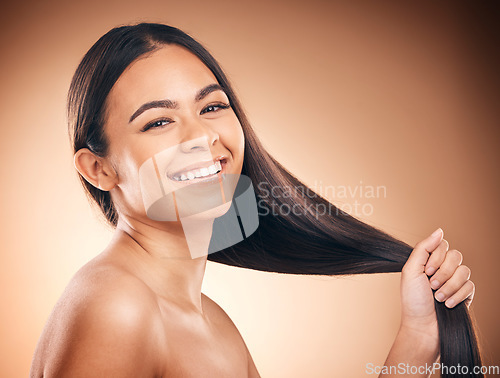 Image of Woman, hair style and cosmetic in studio portrait for beauty, healthy shine and smile by brown background. Girl, youth model and haircare with cosmetics, hand and self care for aesthetic by backdrop