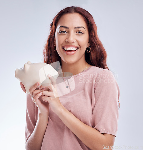 Image of Finance, portrait or happy woman with a piggy bank for financial wealth or savings on white background. Smile, investment or girl laughing or investing cash or budget in tin for safety or security