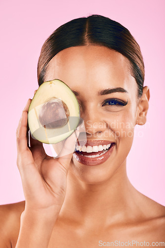 Image of Happy woman, portrait and avocado for natural skincare, beauty or cosmetics against a pink studio background. Female person or model smile with vegetable for healthy nutrition, fiber diet or wellness