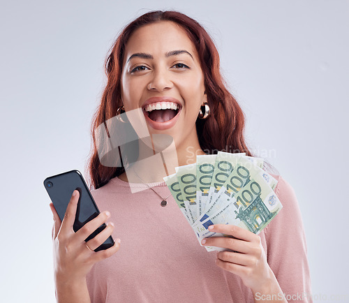 Image of Woman, money and phone in studio portrait, winning and happy with online gambling by white background. Excited girl, smartphone or cash fan with smile for fintech app, digital casino or crypto profit