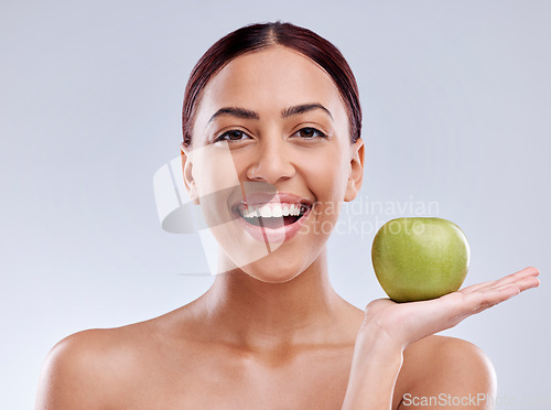 Image of Apple, portrait or happy woman in studio eating on white background for healthy nutrition or clean diet. Smile, hand or excited girl showing natural organic green fruits for wellness or digestion
