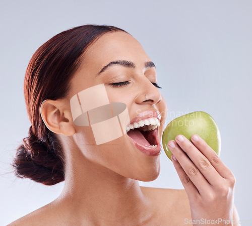 Image of Apple, bite or happy woman in studio eating on white background for healthy nutrition or clean diet. Smile or hungry beautiful girl with open mouth for natural organic green fruits for wellness