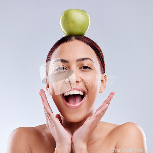 Image of Apple, balance or portrait of excited woman in studio on white background for healthy nutrition or clean diet. Smile, wow or happy girl advertising or marketing a natural green fruit for wellness