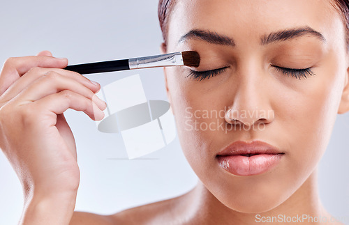 Image of Face, eyeshadow makeup or girl with brush for grooming in studio isolated on white background. Cosmetics, eyes closed or female model with tool or product for skincare, beauty aesthetics or wellness