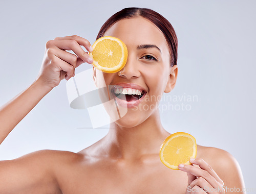 Image of Skincare, portrait or happy woman with orange or natural facial with citrus or vitamin c for wellness. Studio background, smile or healthy girl smiling with organic fruits for dermatology beauty