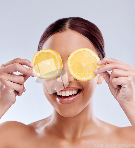 Image of Skincare, mockup or happy girl with orange as natural facial with citrus or vitamin c for wellness. Studio background, smile or healthy female model smiling with organic fruits for dermatology beauty