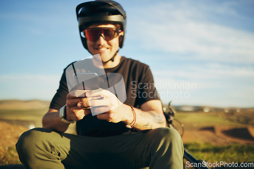 Image of Biker, outdoor and man with a smartphone, typing and connection for social media, network and communication. Male person, cyclist or guy with a cellphone, mobile app and texting with sms and chatting