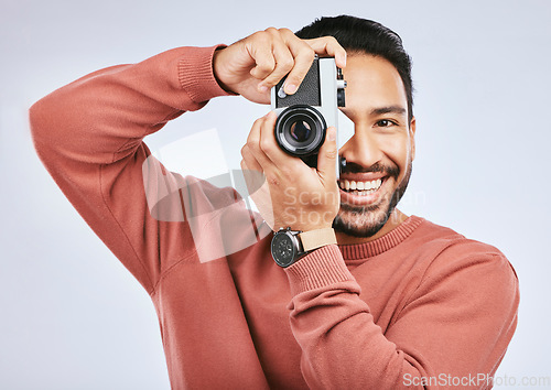 Image of Man with camera, photography and smile in portrait with creativity and art isolated on studio background. Happy male photographer, creative with artistic person and taking pictures with gadget