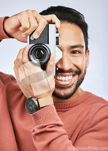 Image of Happy man with camera, photography and smile in portrait with creativity and art isolated on studio background. Male photographer, creative with artistic person and taking pictures with gadget