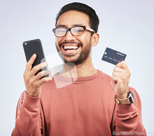 Image of Man is laugh, smartphone and credit card for online shopping, happy with discount or promo on studio background. Positive customer experience, ecommerce and fintech, funny with male person and sale