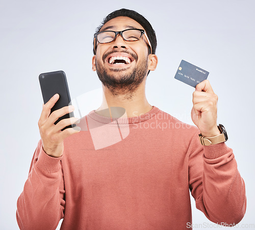 Image of Man is excited, smartphone and credit card, online shopping and bonus with success on studio background. Happy customer experience, ecommerce and fintech, male person celebrate winning and sale