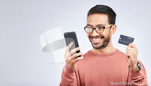 Image of Happy man, smartphone and credit card for online shopping, discount or promo isolated on studio background. Positive customer experience, ecommerce and fintech, male person and sale with mockup space