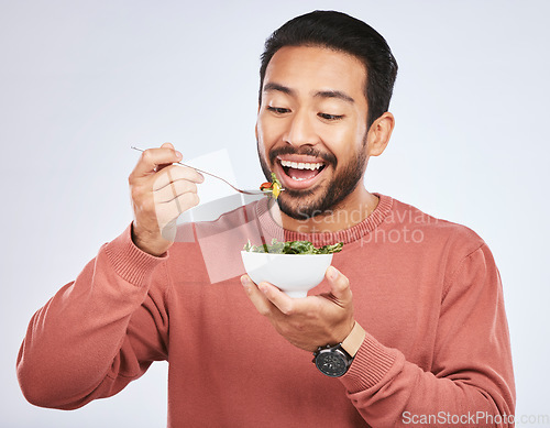 Image of Man is eating salad, healthy food and nutrition with diet, detox and vegetables isolated on studio background. Health, wellness and vitamins with hungry male person, eat meal and lose weight