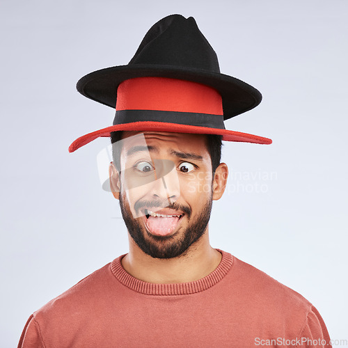 Image of Silly, hats and goofy man in a studio with a crazy, funny and comic face expression or pose. Comedy, happy and Mexican male person with fun head accessories and humor isolated by a white background.