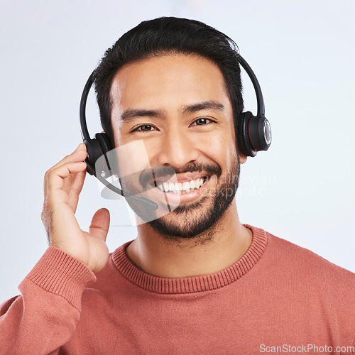 Image of Man with headset, call center and contact us in portrait, smile and communication on studio background. Customer service, telemarketing and tech support with male consultant at help desk job