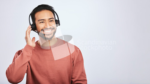 Image of Man with headset, call center and contact us with smile, mockup space and communication on studio background. Customer service, telemarketing and tech support with male consultant and help desk job