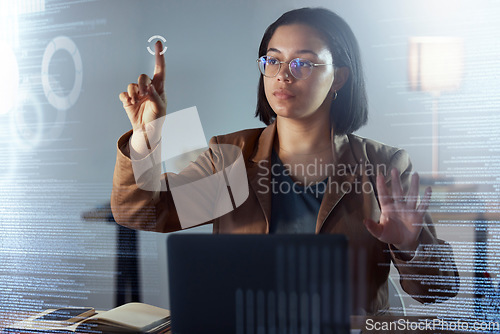 Image of Woman, night and touch hologram with data, chart or information on dashboard, overlay or focus in office. Holographic ux, point and it expert by laptop, analytics or cloud computing in dark workplace