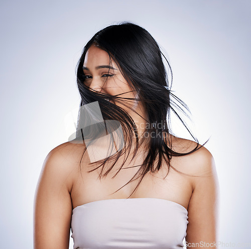 Image of Shake head, happy and woman with hair care, beauty and volume against a studio background. Female person, excited girl and model with salon treatment, grooming and self care with flip and wind