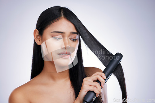 Image of Hair, worry and unhappy woman with straightener for straight hairstyle, salon treatment and white background in Brazil. Beauty, heat damage and stress, face of latino model with flat iron in studio