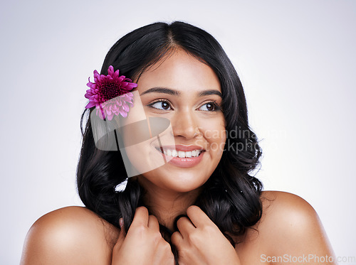 Image of Beauty, smile and face of happy woman with flower in hair, natural makeup and salon treatment on white background. Nature, hairstyle and flowers, face of latino model with haircare on studio backdrop