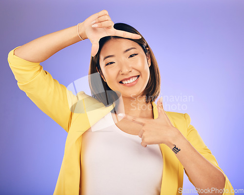 Image of Portrait, frame and Asian woman with a smile, selfie and happy against a studio background. Face, female person or photographer with hand gesture, moment and creative perspective and finger framing