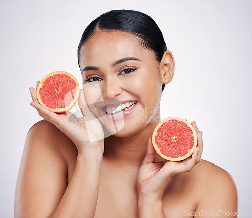 Image of Happy woman, portrait and grapefruit for skincare vitamin C, beauty or cosmetics against a white studio background. Female person smile with fruit in healthy nutrition, natural healthcare or facial