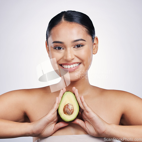 Image of Happy woman, portrait and avocado in natural beauty, skincare or cosmetics against a white studio background. Face of female person smile, fruit or vegetable in healthy nutrition, fiber or wellness