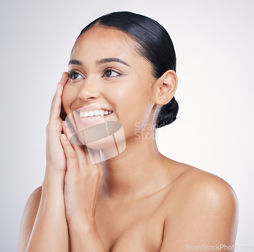Image of Beauty, smile and woman with hands on face in studio for glow, dermatology or natural cosmetics. Happy aesthetic model person thinking of self care, facial or skincare results on a white background