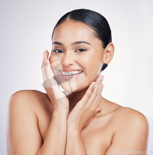 Image of Natural, beauty and woman with hands on face in studio for glow, dermatology or cosmetics. Portrait of a happy aesthetic model person with self care, facial or skincare results on a white background