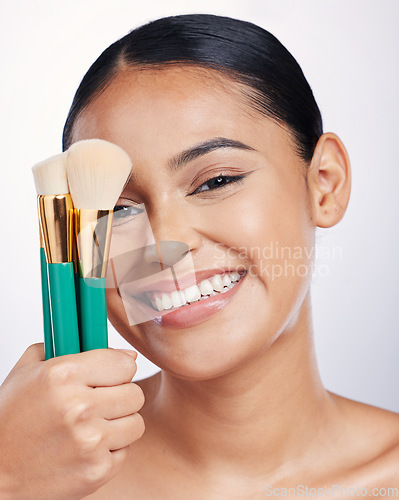 Image of Brush for makeup, face and beauty with happy woman, foundation and portrait isolated on studio background. Female model smile, natural cosmetics and skin glow with cosmetic tools and cosmetology