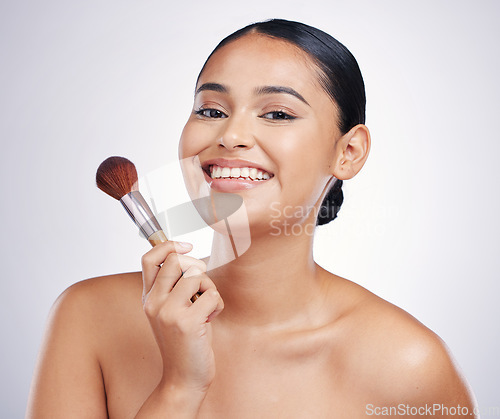 Image of Makeup brush, woman with smile in portrait and beauty, foundation and powder isolated on studio background. Female model, face with natural cosmetics and skin glow with cosmetic tools and cosmetology