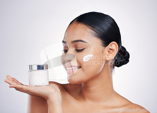 Image of Happy woman, face cream and product in skincare cosmetics or moisturizer with smile against a white studio background. Female person or model smiling for beauty lotion or facial treatment on mockup