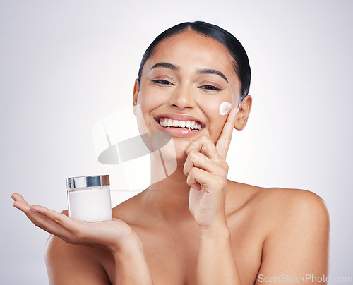 Image of Happy woman, portrait and cream product in skincare, moisturizer or cosmetics against a white studio background. Female person or model smiling for cosmetic lotion or facial treatment on mockup space